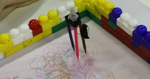 Robot-compass is drawing circles with colored felt-tip pens Stock Footage 106273256