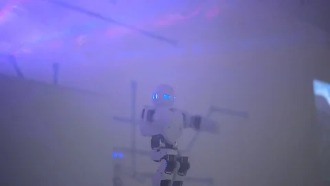 Robot dances in smoke Stock Footage 73420918