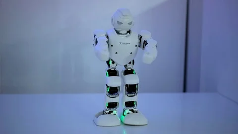 Robot dances under the light Stock Footage 73420109