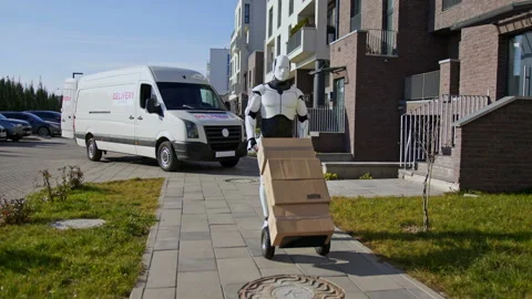Robot delivering parcel box to recipient, walking along the street with trolley Stock Footage 166175905