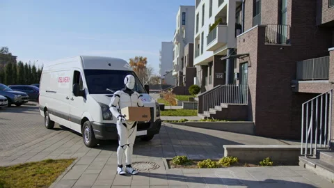 Robot delivering parcel box to recipient, walking along the street carring Stock Footage 166176076