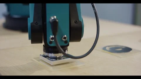 Robot End Effector with Metal Flange Pressing Sample Plate on Bench, Close Up Stock Footage 341298578