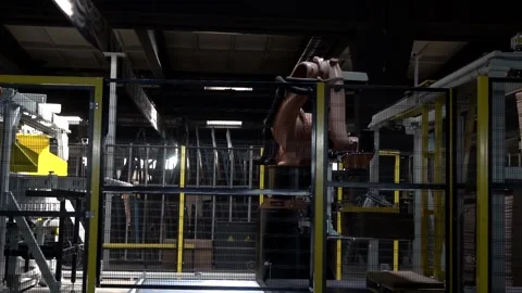 Robot in a factory used for palletizing Stock Footage 237551646