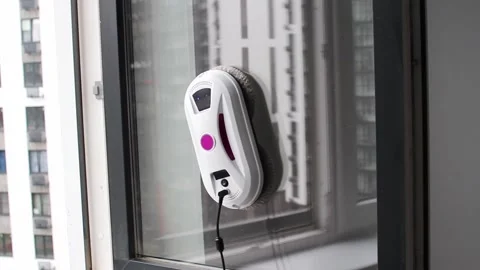 Robot glass washer. Cleaner of multi-storey building washes window. Stock Footage 250956617