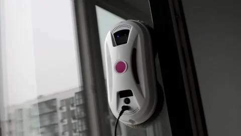 Robot glass washer. Cleaner of multi-storey building washes window. Stock Footage 251859312