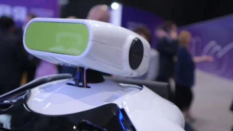 Robot with green sensor head shown at indoor event Stock Footage 345702022