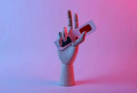 Robot hand holding a small white and red object 스톡 사진