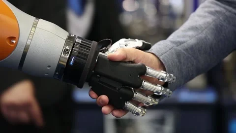 Robot hand shaking human hand. Schunk gripper demonstration Stock Footage 90104348