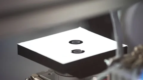 The robot hand takes the pcb from the test equipment and puts it on conveyor Stock Footage 137670629