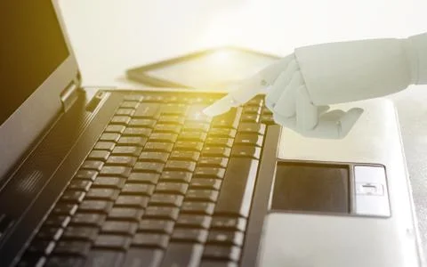Robot hand use laptop computer, Artificial Intelligence Technology Concept. Stock Photos