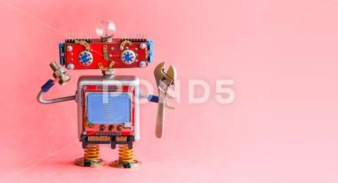 Robot handyman spanner wrench bolt nut in hands. Mechanical cyborg toy, red head Stock Photos
