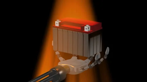 The robot has a car battery in its hand. Stock Footage 334478853