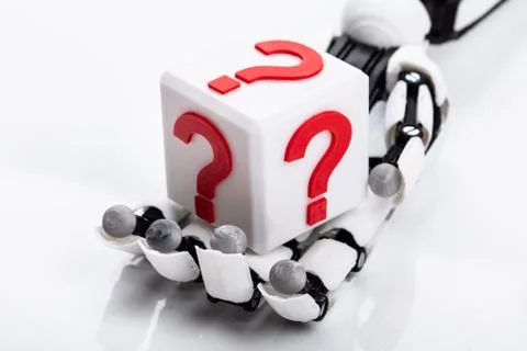 Robot Holding Cubic Block With Question Mark Sign Foto stock