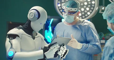 Robot holding digital tablet helps doctor to perform surgical operation in Stock Footage 242327358