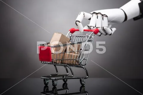 Robot Holding Shopping Cart With Cardboard Boxes Stock Photos
