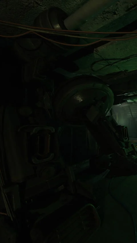 Robot in industrial setting with dim light and wires hanging from ceiling Stock Footage 339947311