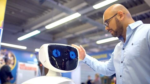 Robot with interactive display communicates with visitors in a business centre Stock Footage 86448565