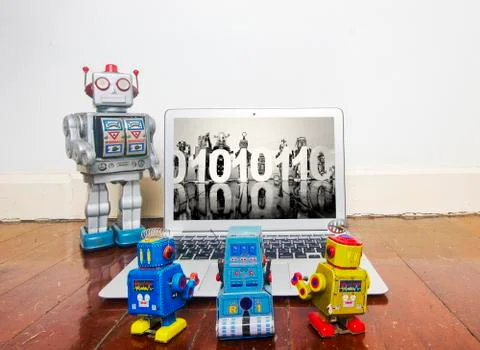 Robot kids learn code from a laptop Stock Photos