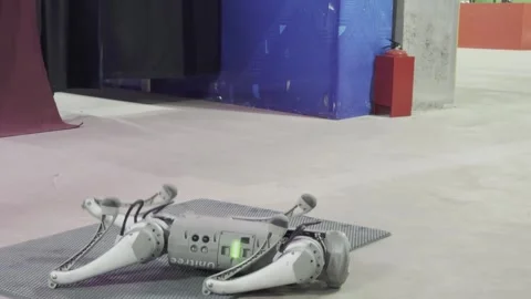 A robot with the letters G0O on it is standing on a gray surface 库存影片 279823537