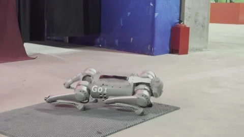 A robot with the letters G0O on it is standing on a gray surface 스톡 동영상 283484721