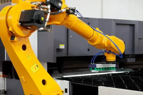 Robot loading steel sheets in press brake machine Stock Photos