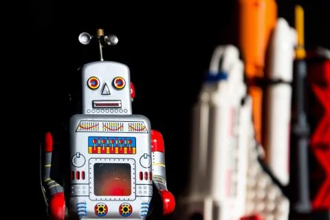 Robot looking into the future of space exploration with rocket Stock Photos