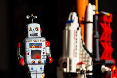 Robot looking into the future of space exploration with rocket Stock Photos