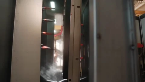 A robot machine paints metal automatically in a factory, a large machine paints Stock Footage 150963746