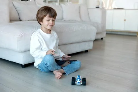 Robot made of bricks is controlled by a kid programmer, who uses tablet pc Stock Photos