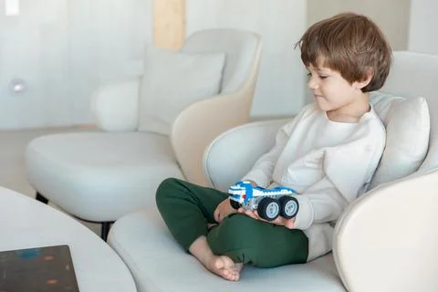 Robot made of bricks is controlled by a kid programmer, who uses tablet pc Stock Photos