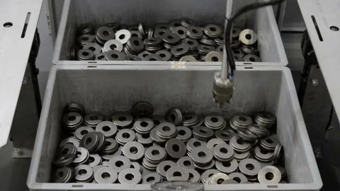 The robot manipulator produces sorting of metal objects. Stock Footage 76563994