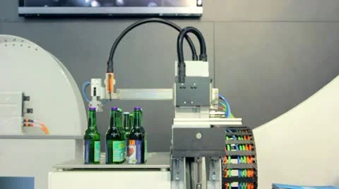 Robot moves bottles for drinks Stock Footage 12175556