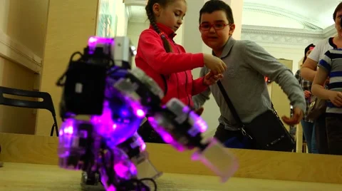 Robot. New technologies.  AI. Children watching the dancing robots. Stock Footage 50227837