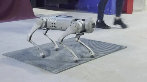 A robot with the number 1 on it is walking on a grey surface Stock Footage 279823352