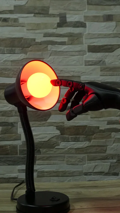 Robot or Prosthesis Hand Touching Glowing Smart Bulb in Desk Lamp Stock Footage 339242174