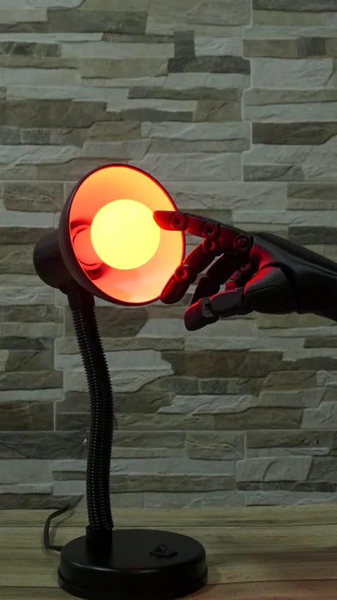 Robot or Prosthesis Hand Touching Glowing Smart Bulb in Desk Lamp Stock Footage 340387044