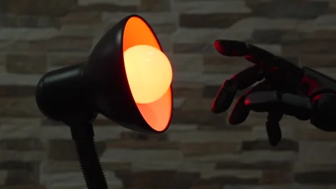 Robot or Prosthesis Hand Touching Glowing Smart Bulb in Desk Lamp Stock Footage 340550676
