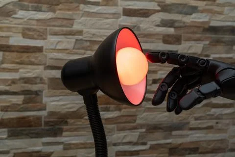 Robot or Prosthesis Hand Touching Glowing Smart Bulb in Desk Lamp Stock Photos