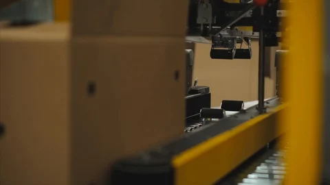 The robot packer at the factory. Machine packed parcels closeup Stock Footage 90422754