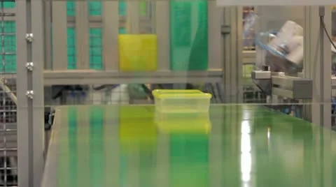 Robot packs boxes and put to conveyer Stock Footage