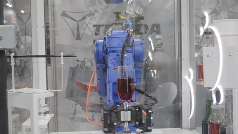 Robot performs task pouring drink glass industrial robot Industrial manipulators Stock Footage 324551134