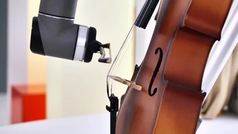 Robot playing cello during exhibition, blending technology and classical music Video stock 322028204