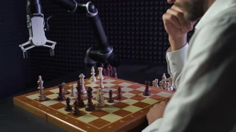 Robot playing chess with a man, the confrontation between man and artificial Stock Footage 133308053