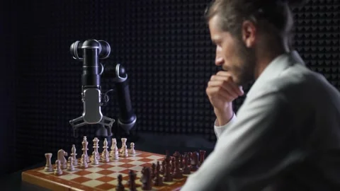 Robot playing chess with a man, the confrontation between man and artificial Stock Footage 133311342