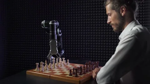 Robot playing chess with a man, the confrontation between man and artificial Stock Footage 133398886