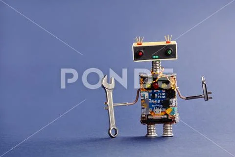 Robot serviceman with hand wrench and screwdriver on blue background. Abstract Stock Photos