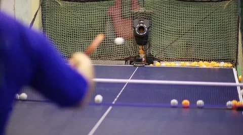 The robot serving the tennis balls, which are beaten by player Video stock 61772015