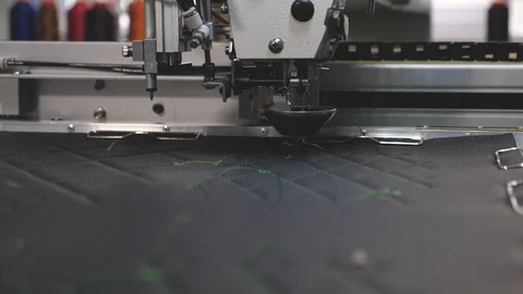Robot sewing machine. an automated machine embroidery pattern with red threads Stock Footage 108666528