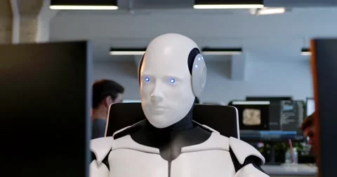 Robot sitting at table in office and typing on keyboard. Cyborg working at Video stock 180023722
