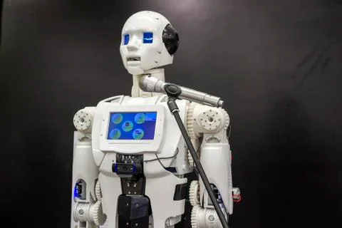 The robot speaks in front of the microphone Stock Photos